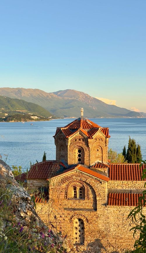 Free Stunning view of a historic church by Lake Ohrid with mountainous background in North Macedonia. Stock Photo