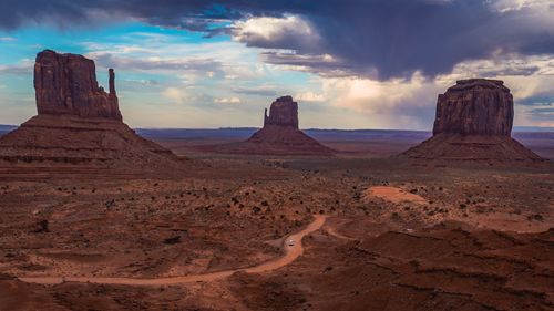 Free Scenic view of Monument Valley's iconic buttes under a dramatic sky in Arizona. Stock Photo