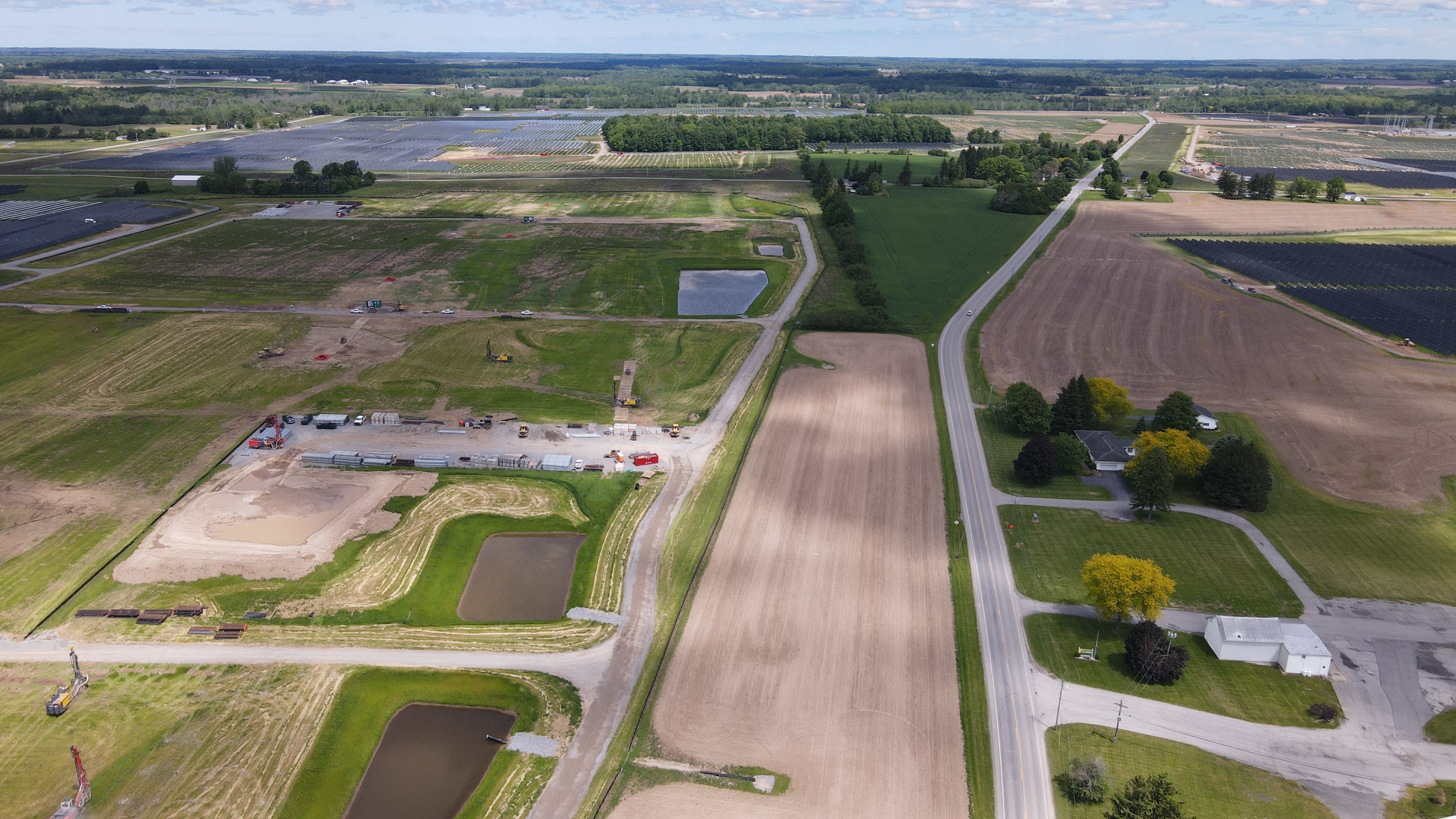 Aerial view of a solar farm in a grassy field
