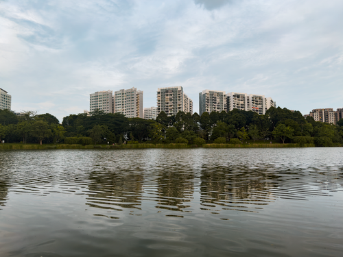 Free Scenic view of modern buildings reflected in a tranquil lakeside setting. Stock Photo