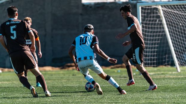 Intense soccer match with players in action, showcasing skills and teamwork.
