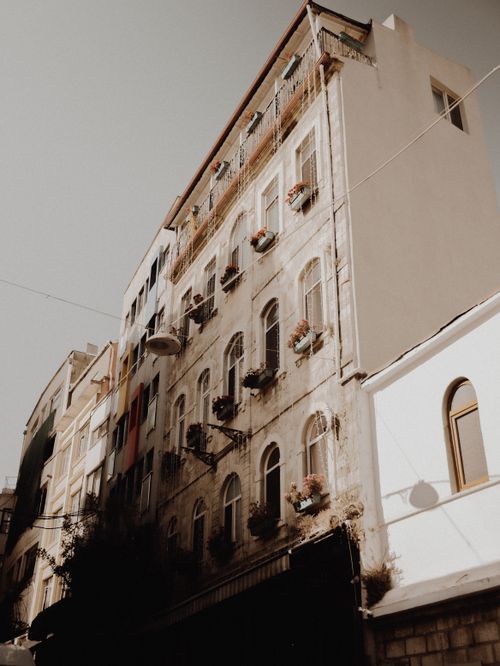 Free Vintage buildings in Istanbul illuminated by warm sunlight, showcasing charming urban architecture. Stock Photo