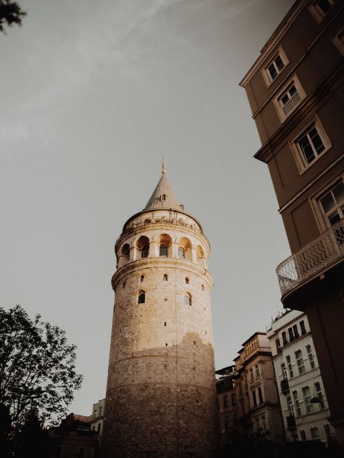 Free Explore the historic Galata Tower, bathed in warm dusk light, a true Istanbul landmark. Stock Photo