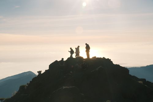 Free Hikers silhouette against a sunrise backdrop on Mount Rinjani, Indonesia. Stock Photo