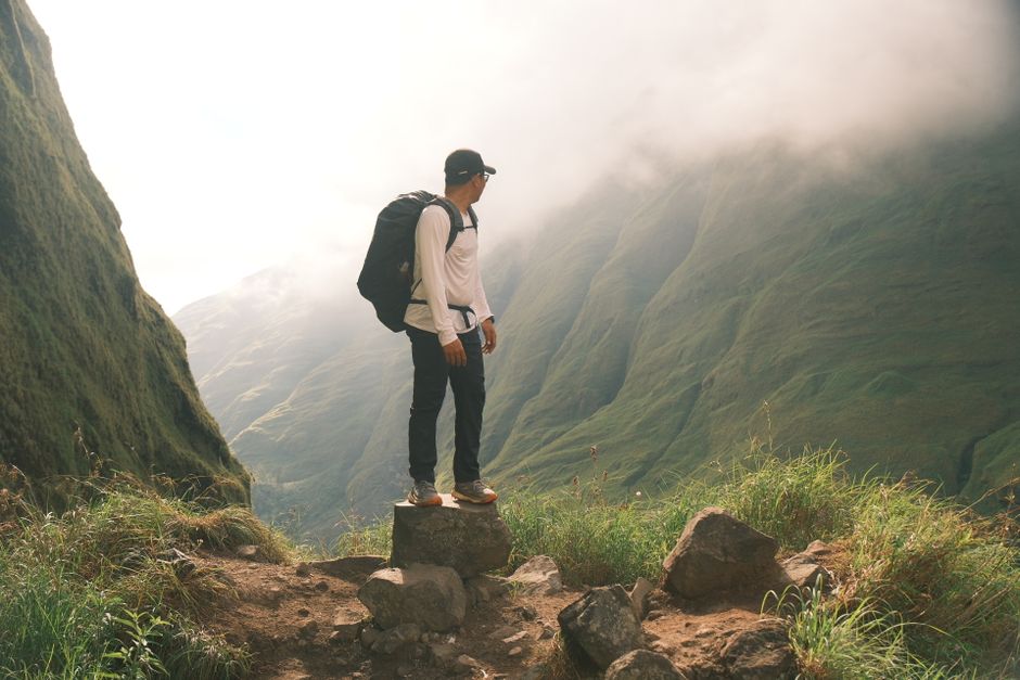 Incredible Kayaking Tour - Bay of Paraty & Manguezal Review: Your Ultimate Guide to Brazil's Hidden Waterways Review 2026 - A hiker stands on a rock, overlooking the lush valleys of West Nusa Tenggara, Indonesia.