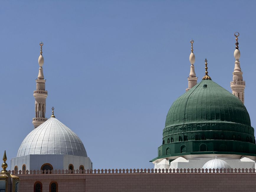 Stunning view of the Prophet's Mosque domes with clear blue sky in Madinah, Saudi Arabia.