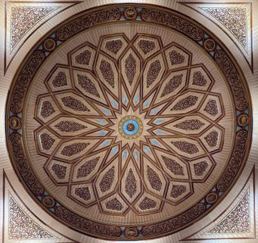 Close-up of ornamental dome design in Madinah mosque, featuring Islamic geometric patterns.