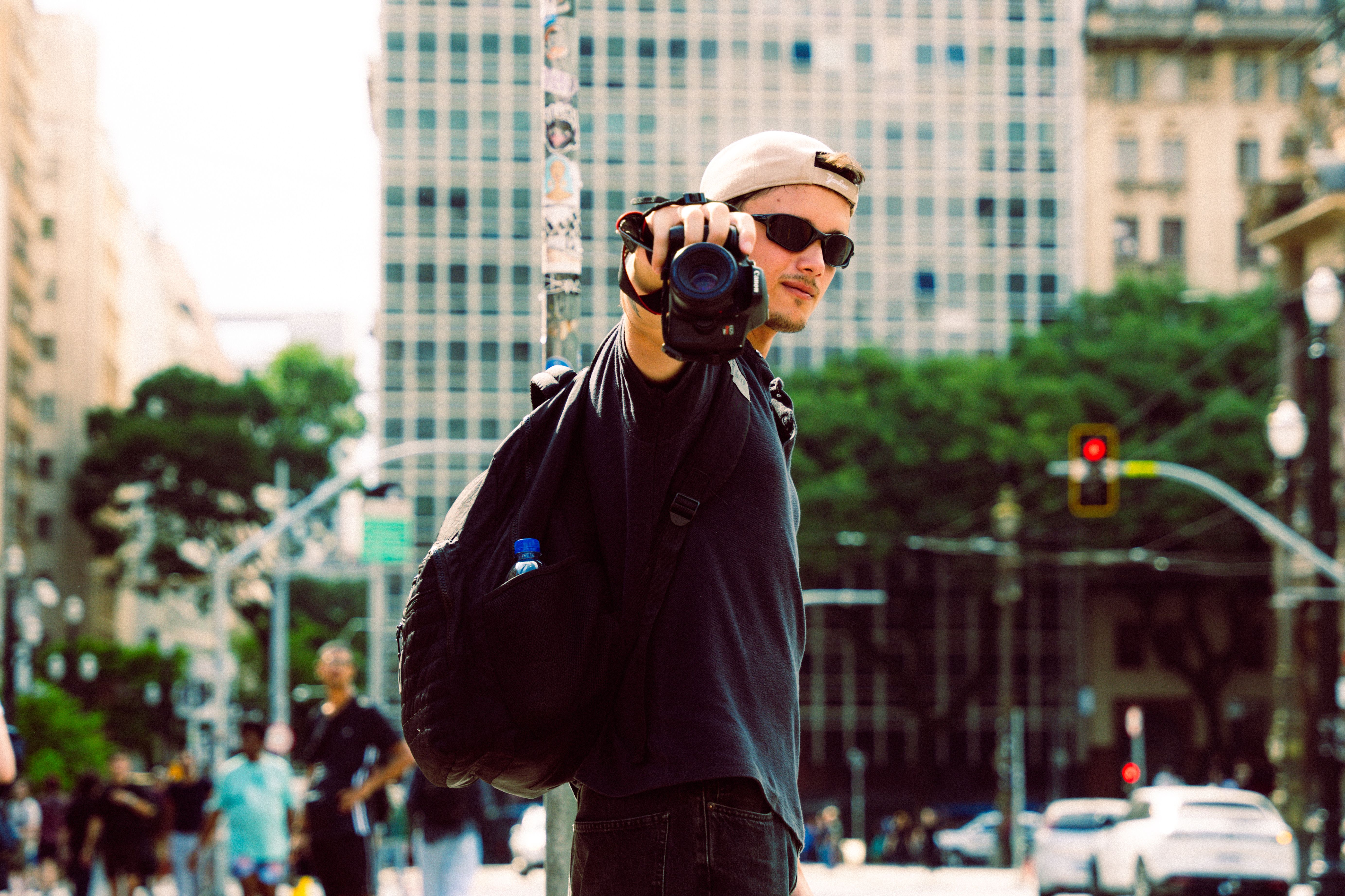 [Smart glasses showing a discrete camera lens recording in a public space]
