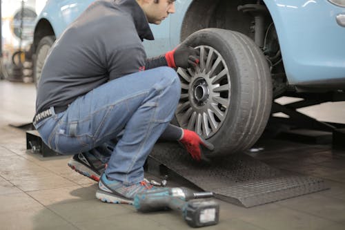 Free Man Changing a Car Tire Stock Photo