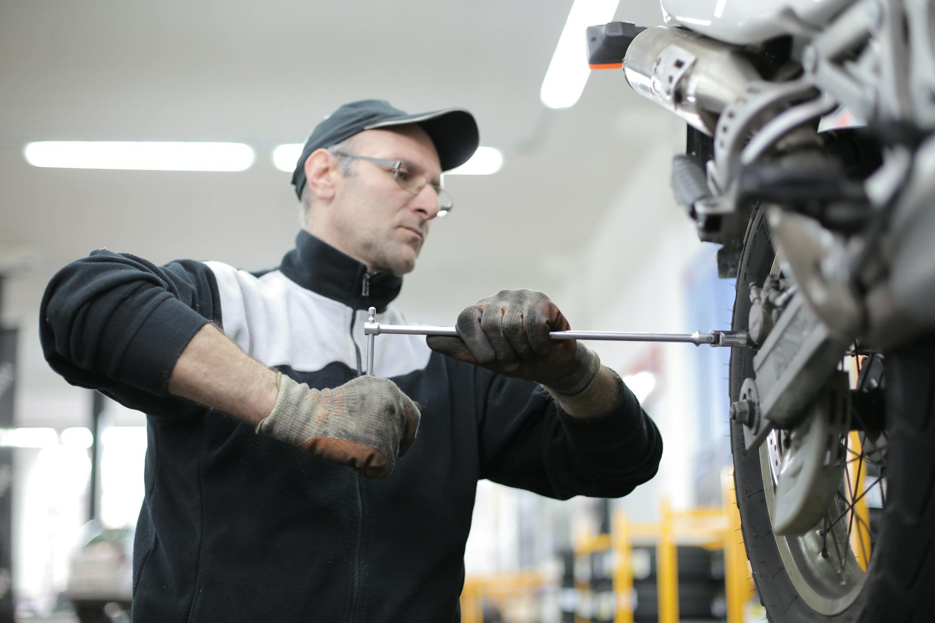 Photo of Man Fixing a Motorcycle