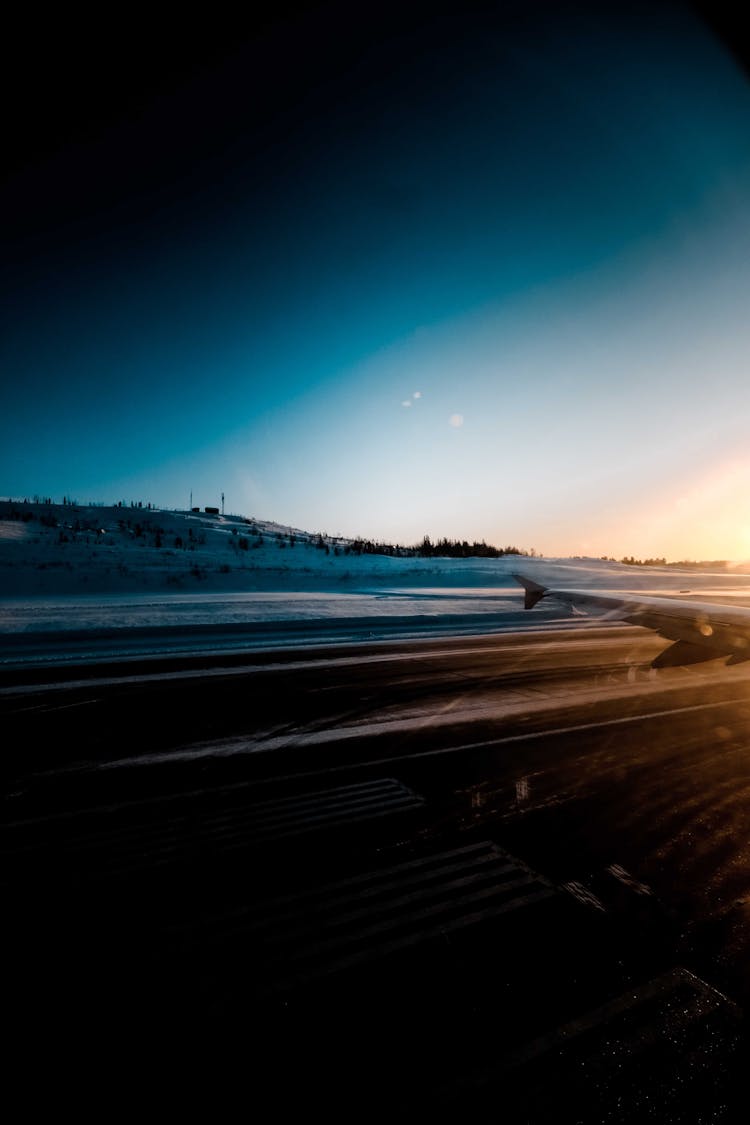 Airfield In Snowy Terrain During Sundown