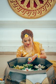 A woman in traditional attire participates in a pre-wedding ritual in Dhaka, Bangladesh.