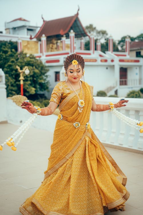 Free Beautiful bride in a golden saree at a heritage location in Dhaka, Bangladesh. Stock Photo