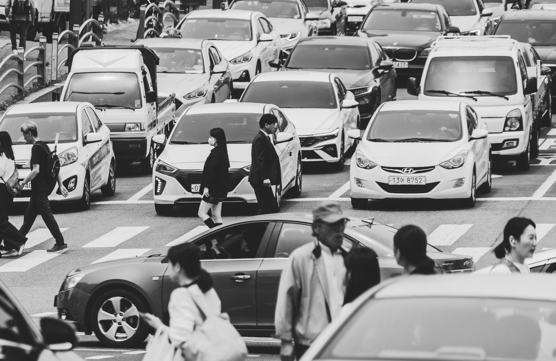 Diverse group of professionals walking through a modern Seoul cityscape, symbolizing job opportunities for foreigners in Korea.