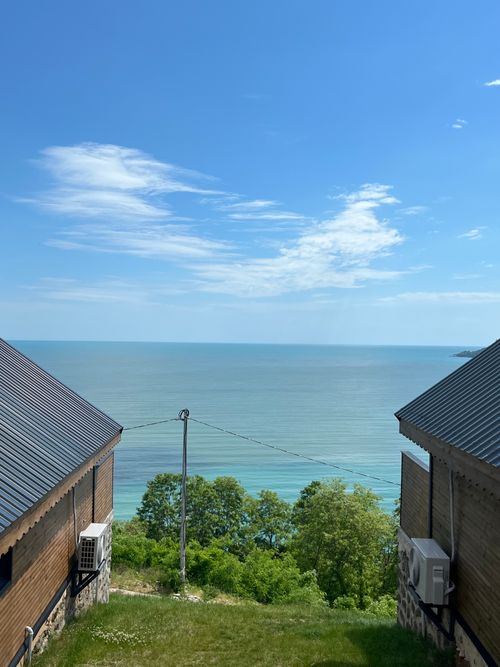 Free Beautiful view of the Black Sea framed by two houses on a sunny day. Stock Photo