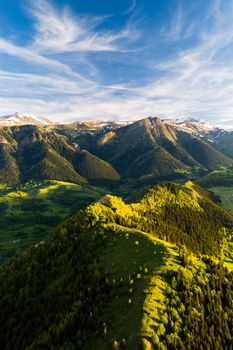 Stunning aerial landscape of the lush green mountains in Artvin, Türkiye, under a clear blue sky.