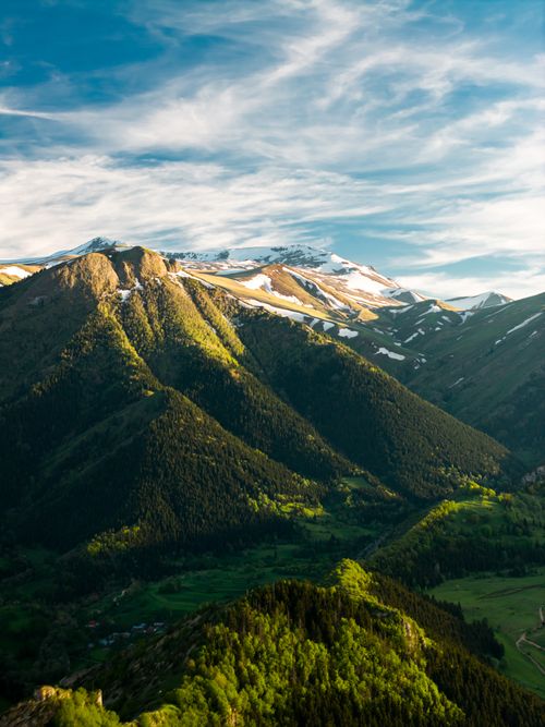Free A breathtaking aerial view of the lush green mountains in Artvin, Türkiye under a bright blue sky. Stock Photo
