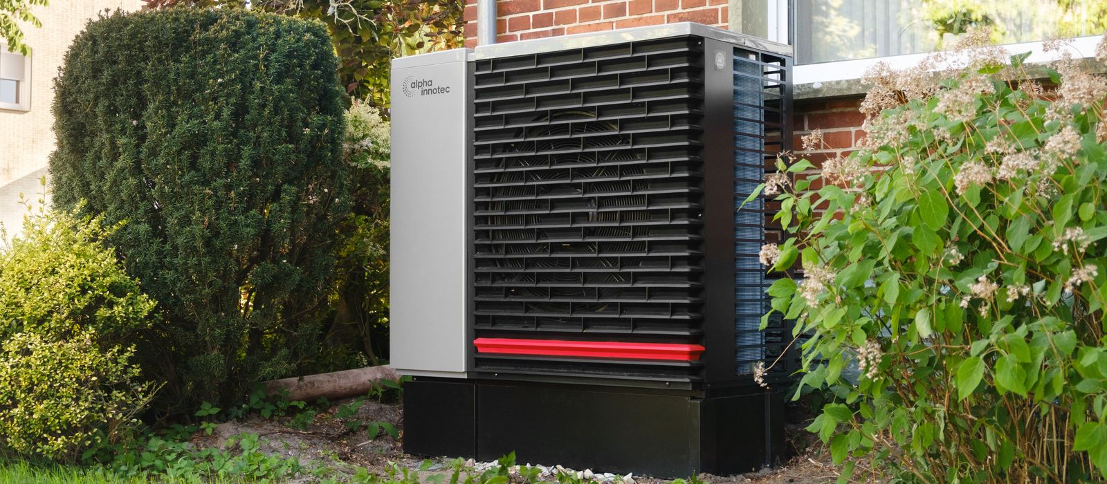 Heat pump outdoor unit beside a house