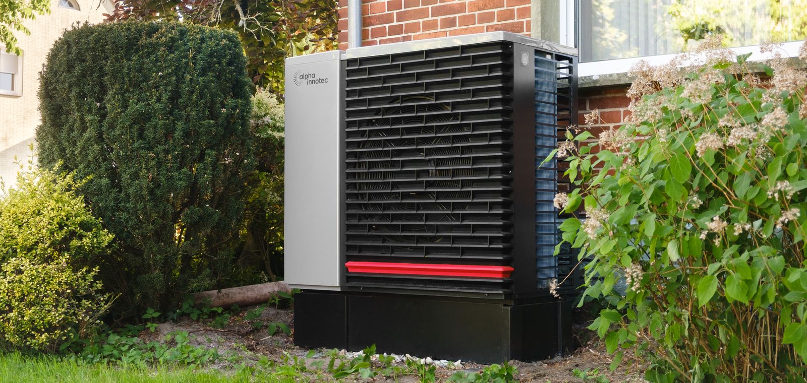 Heat pump outdoor unit beside a house