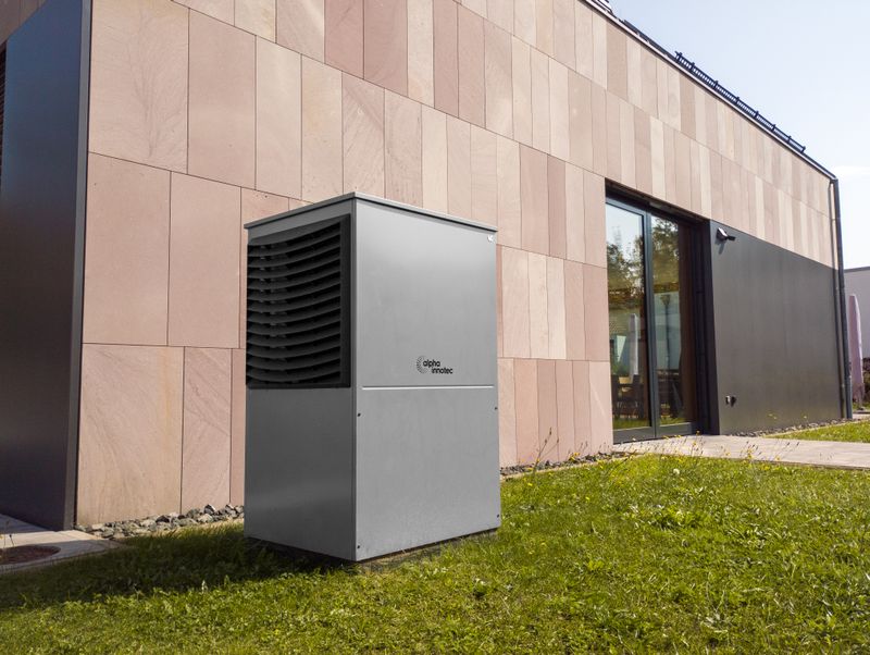 A modern heat pump unit installed outdoors next to a contemporary building