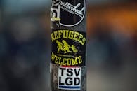 Street metal pillar with various stickers