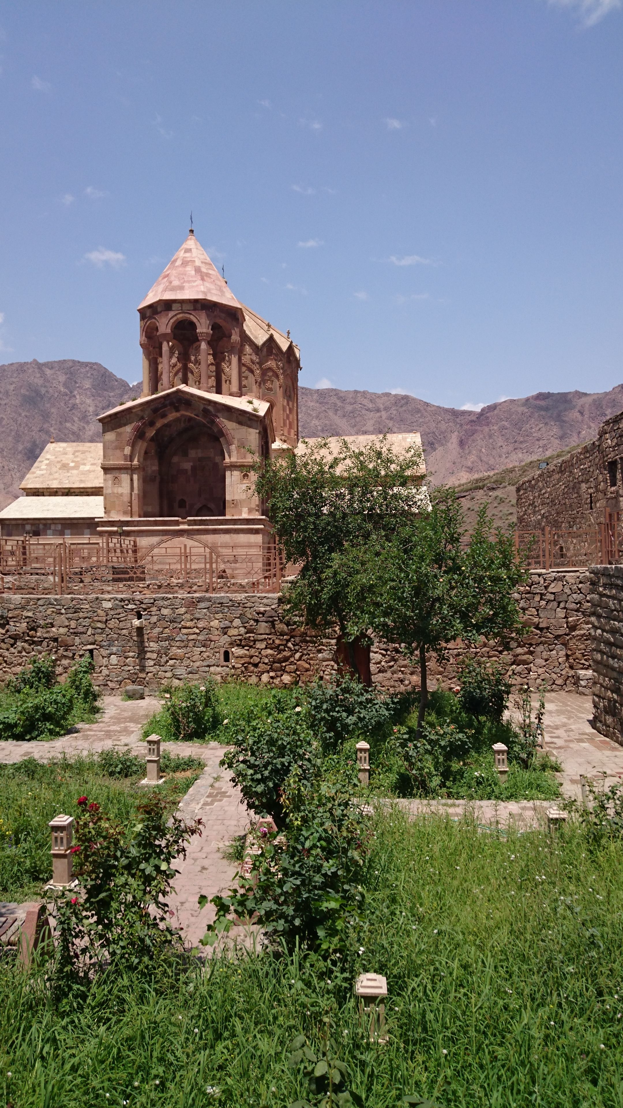 Explore the historic Saint Stepanos Monastery surrounded by vibrant summer greenery.