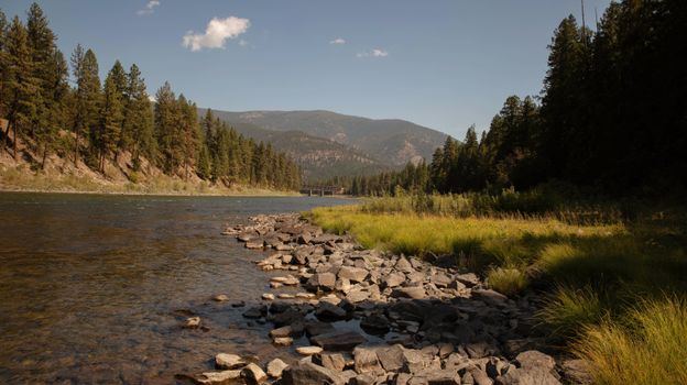 A beautiful view of a river and forest in Saint Regis, Montana, showcasing natural serenity.