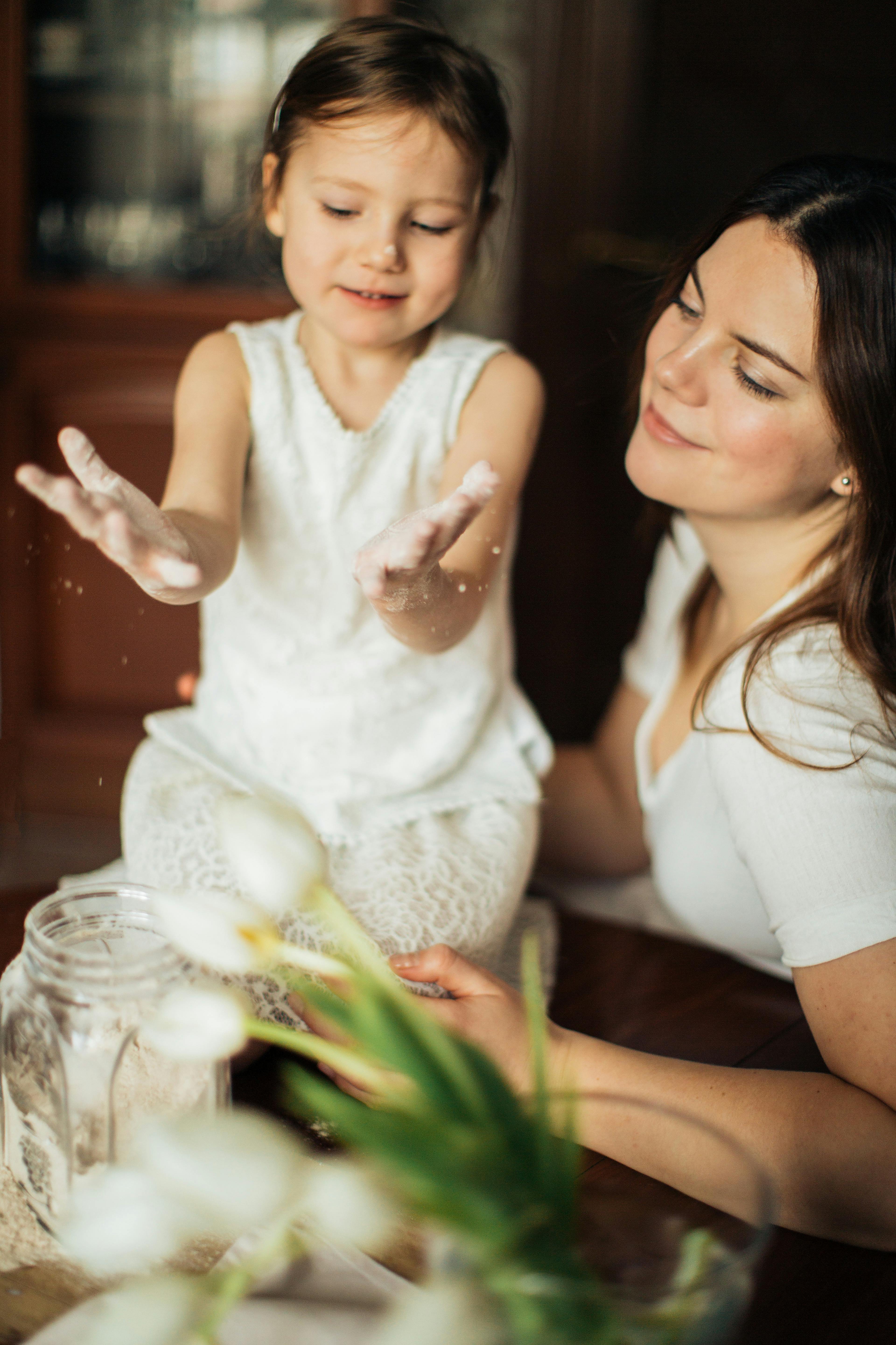 photo of woman sitting near her child