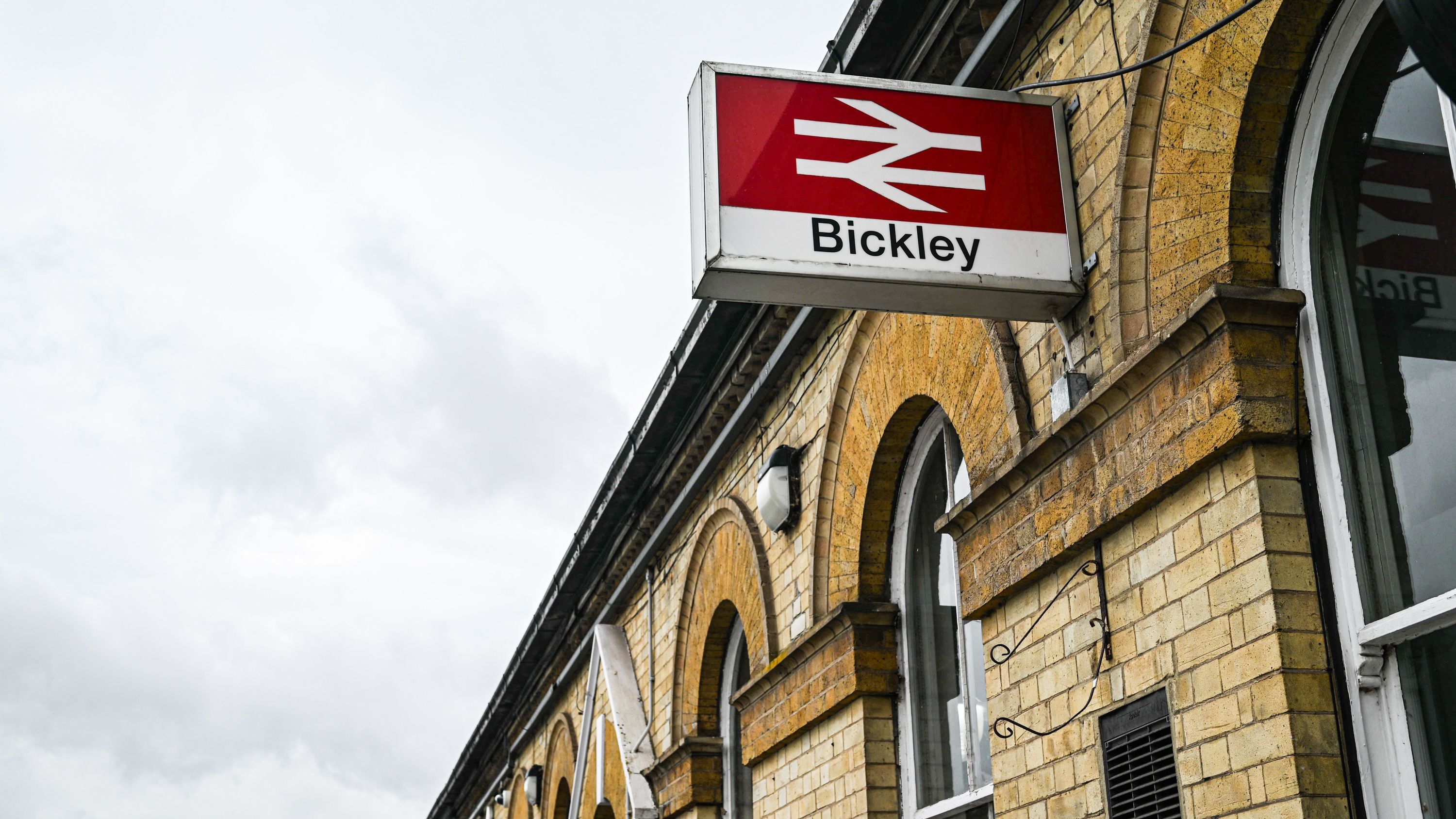 A detailed view of the Bickley train station sign and brick architecture in London, UK.