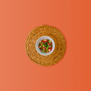 Top view of a vibrant and colorful vegetable salad served in a white bowl.