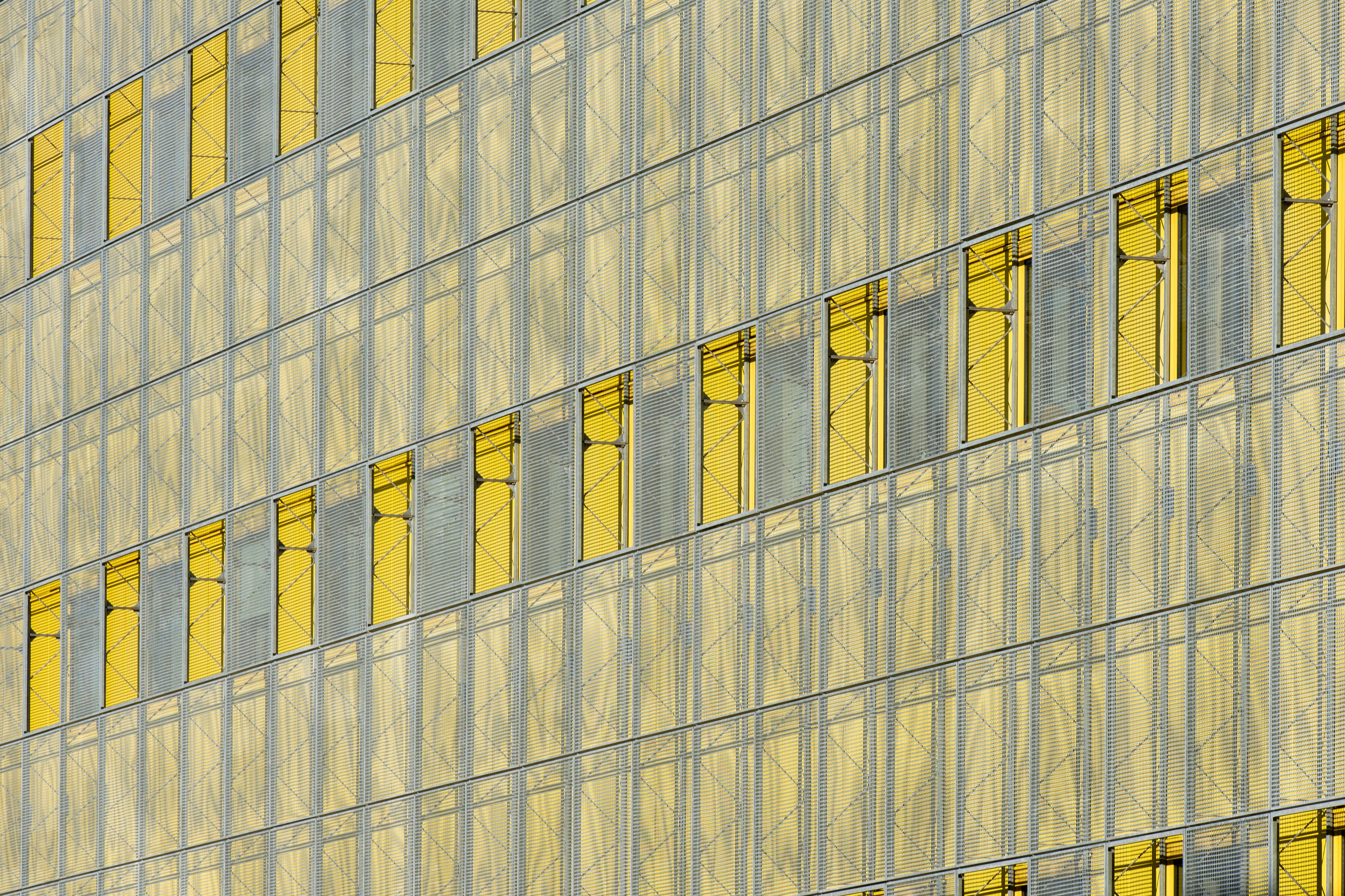 Modern abstract glass facade displaying yellow panels in Zoetermeer.