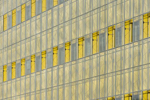 Modern abstract glass facade displaying yellow panels in Zoetermeer.