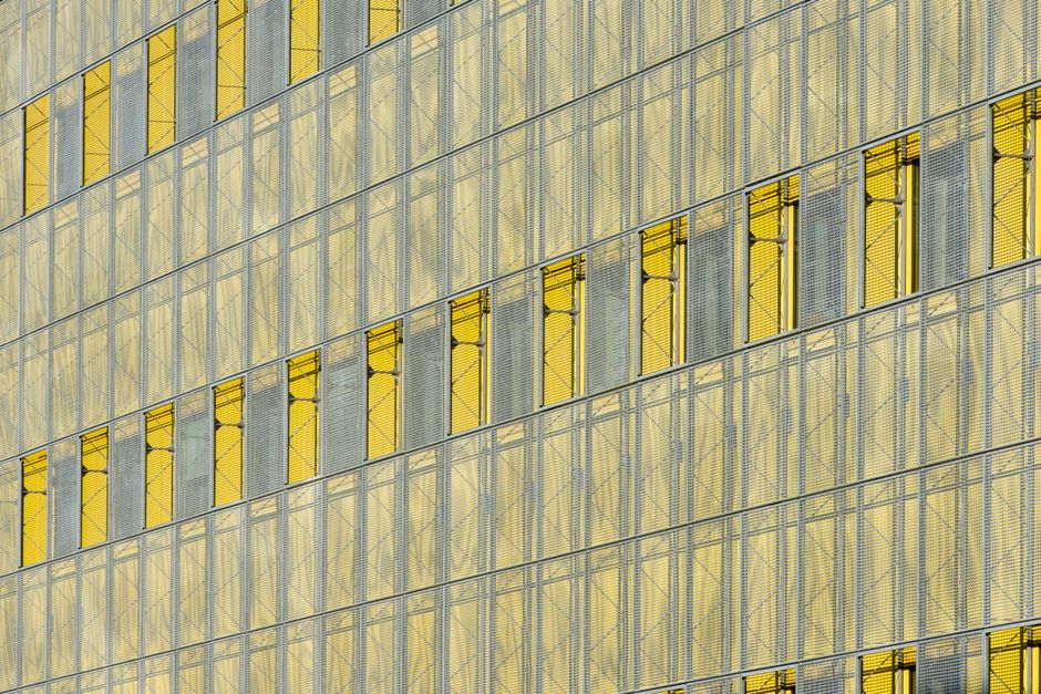 Modern abstract glass facade displaying yellow panels in Zoetermeer.