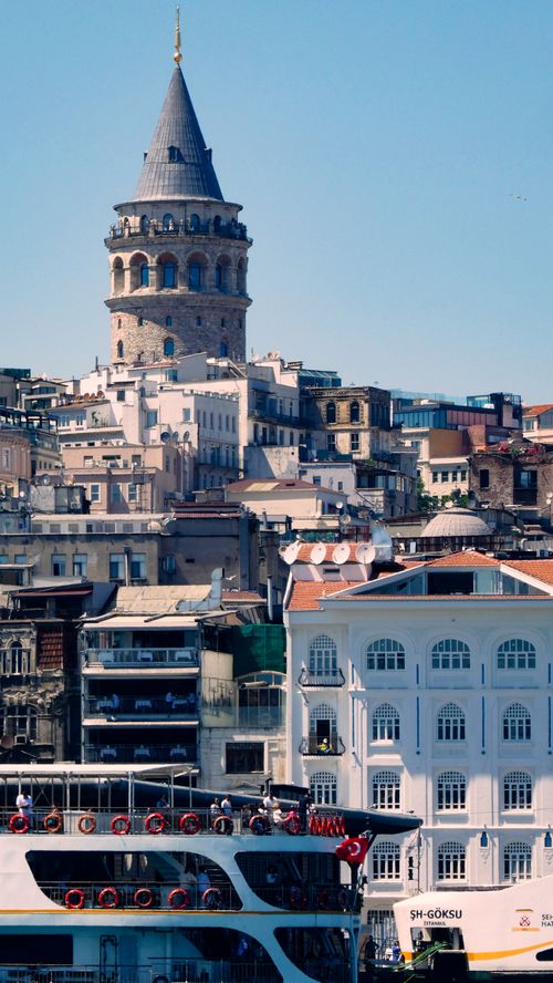 Free View of the iconic Galata Tower with Istanbul's skyline and ferry in the foreground. Stock Photo