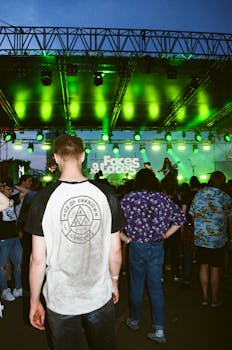 Energetic crowd enjoying a live rock band performance under vibrant stage lights in Moscow.