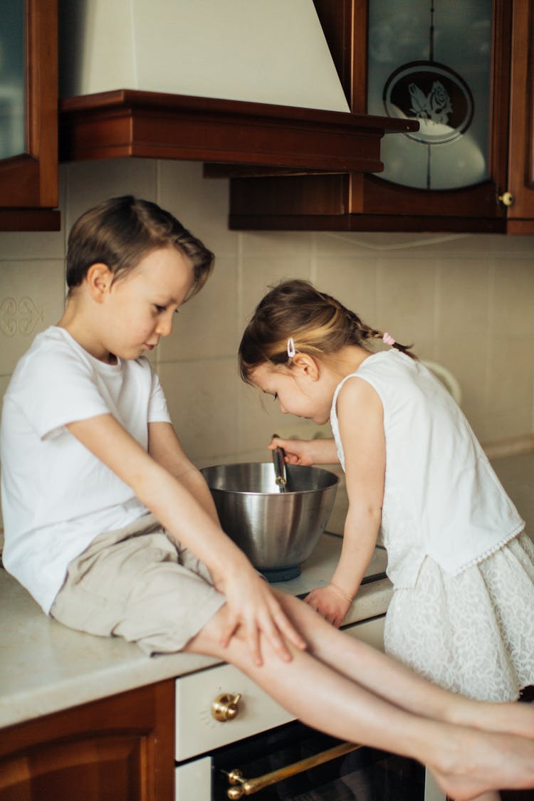 Photo Of Boy Sitting On Kitchen Counter Top