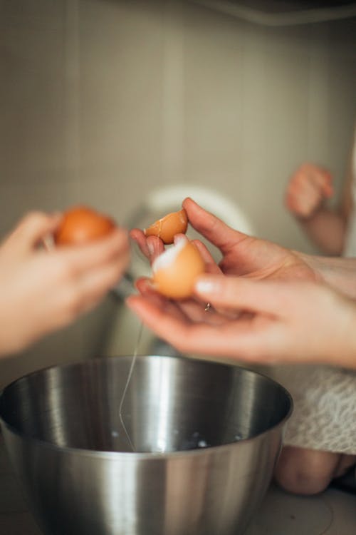Selective Focus Photo of Person Holding Brown Eggs