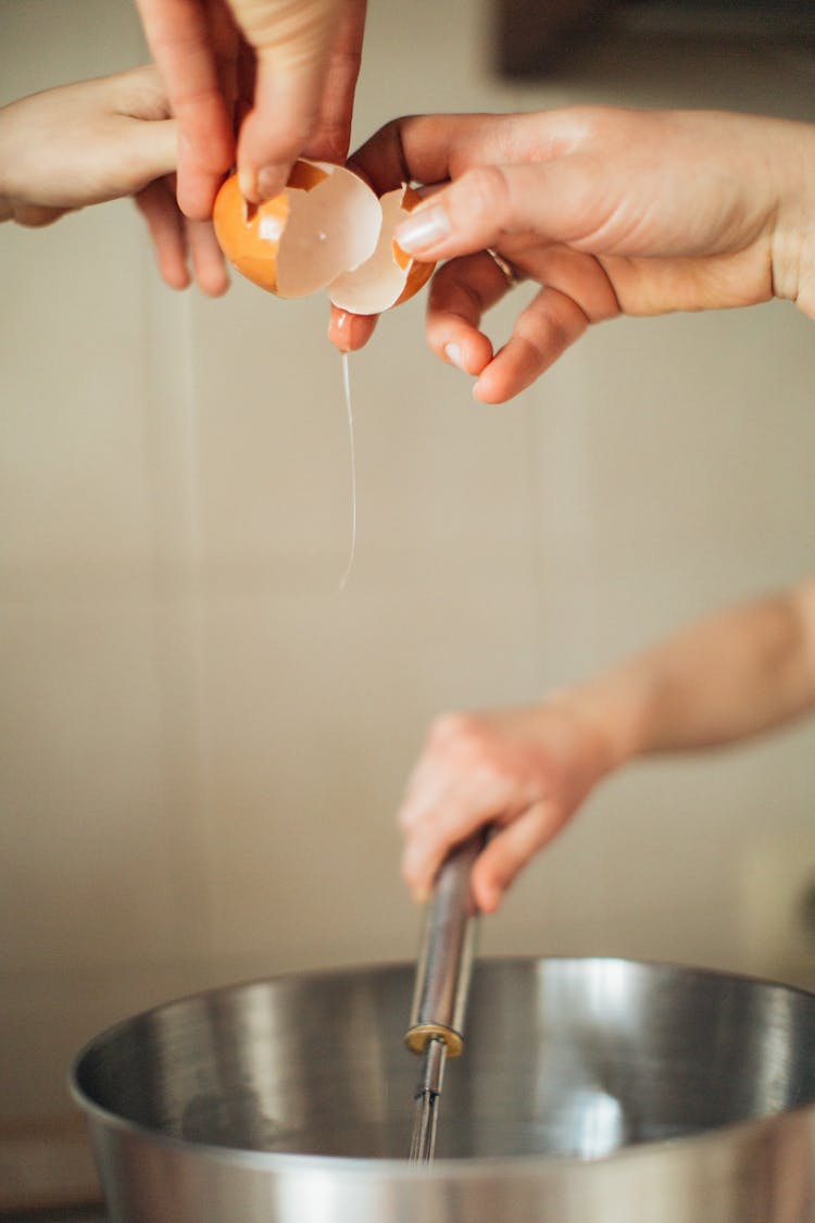 Person Holding Cracked Brown Eggs