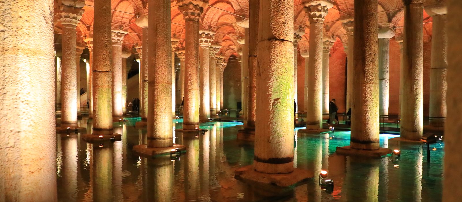 Explore the illuminated arches and columns of Istanbul's historic Basilica Cistern.
