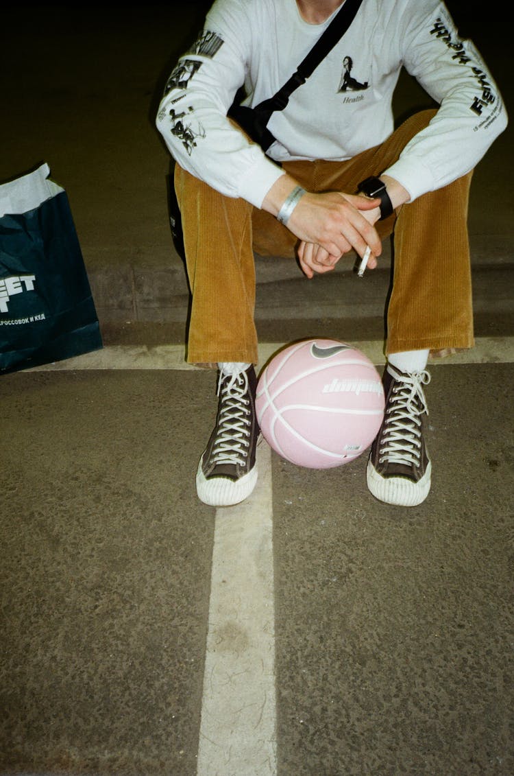 Person Sitting On The Floor And Smoking