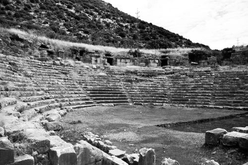 Free Monochrome image of ancient amphitheater ruins set against a hillside, showcasing historical architecture. Stock Photo