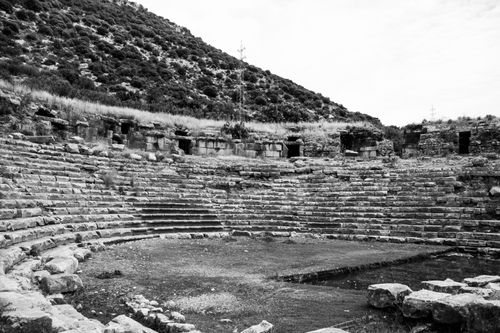 Free Monochrome image of ancient stone amphitheater with hillside backdrop. Stock Photo