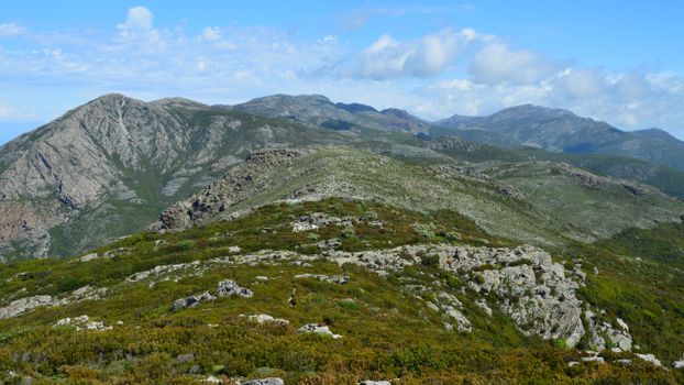 Breathtaking view of rocky mountains and lush greenery in Bastia, Corsica during the day.