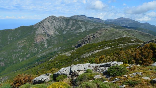 Breathtaking view of mountainous terrain in Bastia, Corsica, under a clear blue sky.