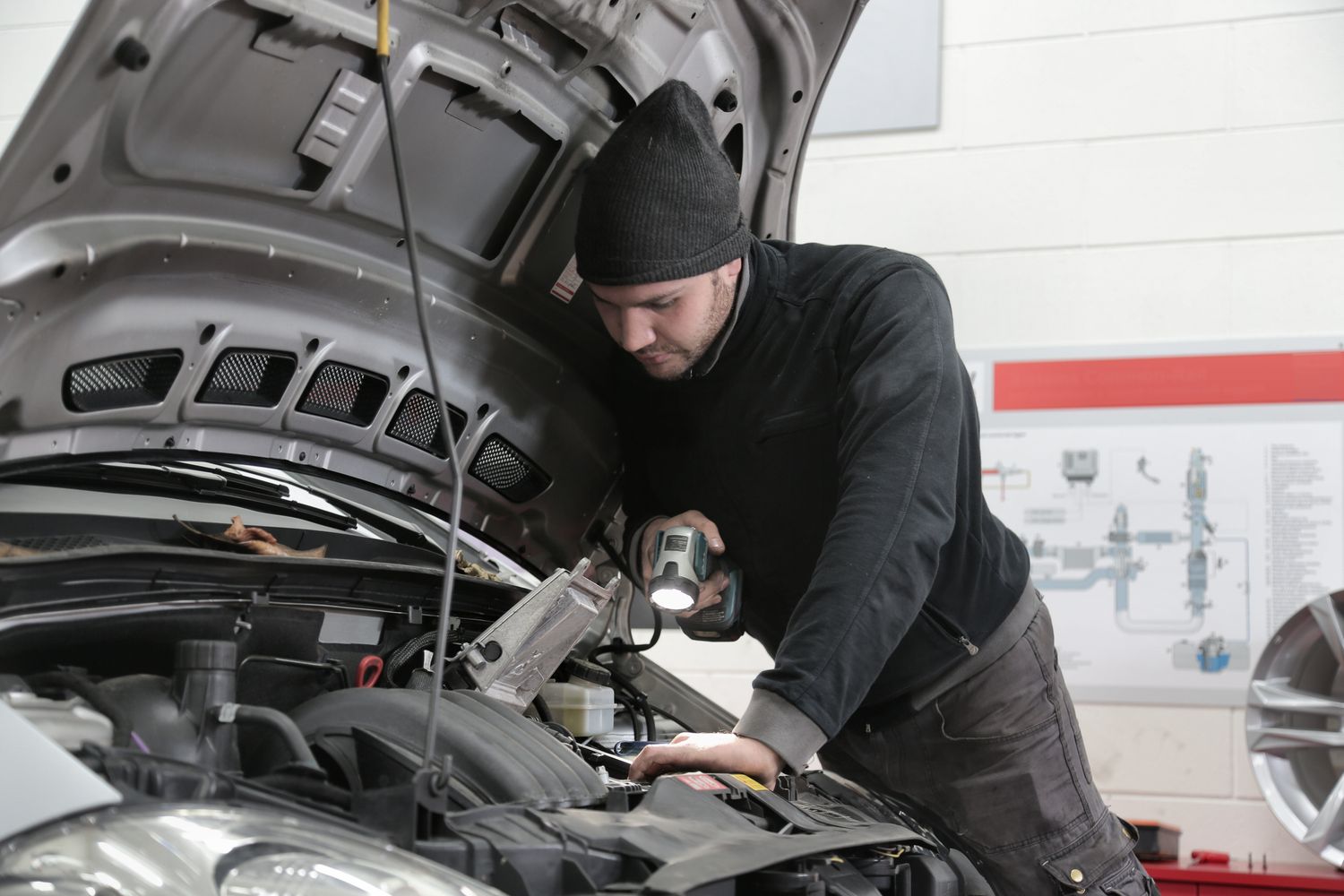 Automotive technician inspecting a vehicle