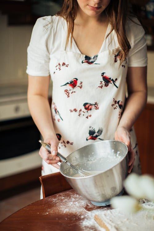 Free Woman Wearing Apron Holding Stainless Steel Bowl Stock Photo