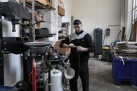 Focused mechanic repairing compressor hose in workshop