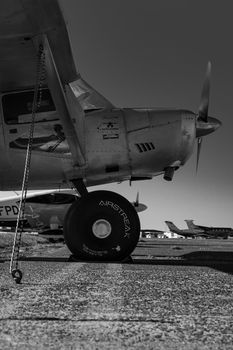 Detailed monochrome view of an airplane wheel on a runway in Sylt, Germany.