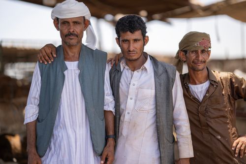 Free Three men in traditional attire pose together outdoors, highlighting cultural diversity and friendship. Stock Photo
