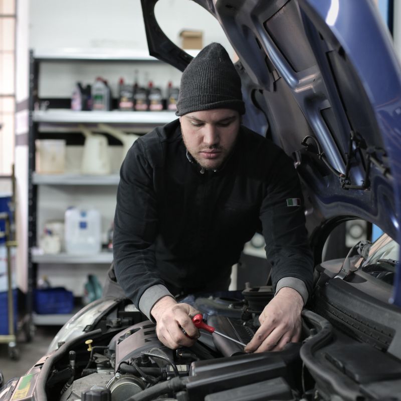 Mechanic performing detailed engine repair and overhaul
